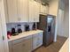 Modern kitchen with stainless steel appliances and white cabinets at 835 Griffon Ave, Lake Alfred, FL 33850