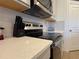 Modern kitchen with stainless steel range and white cabinets at 835 Griffon Ave, Lake Alfred, FL 33850
