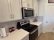 Kitchen with stainless steel appliances and white cabinets at 835 Griffon Ave, Lake Alfred, FL 33850