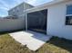 Screened patio with concrete flooring and grassy backyard at 835 Griffon Ave, Lake Alfred, FL 33850