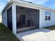 Screened patio with furniture and a grill, adjacent to the house at 835 Griffon Ave, Lake Alfred, FL 33850