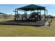 Community playground with shaded play area, swings, and slides at 835 Griffon Ave, Lake Alfred, FL 33850