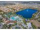 Aerial view of community pool, clubhouse, and surrounding homes at 8886 Geneve Ct, Kissimmee, FL 34747