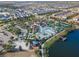 Aerial view showing community pool, clubhouse, and surrounding neighborhood at 8886 Geneve Ct, Kissimmee, FL 34747