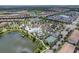 Aerial view of community with resort-style pool, tennis court, and lake at 8886 Geneve Ct, Kissimmee, FL 34747