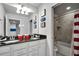 Bathroom with double sinks, granite countertop, and a tub shower combo at 8886 Geneve Ct, Kissimmee, FL 34747