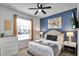 Bedroom with queen bed and accent wall at 8886 Geneve Ct, Kissimmee, FL 34747