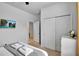 Bright bedroom with a queen bed, TV, and double doors leading to a private bathroom at 8886 Geneve Ct, Kissimmee, FL 34747