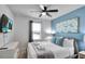Spacious bedroom with a king-size bed, large window, and calming blue wall at 8886 Geneve Ct, Kissimmee, FL 34747