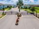 Gated community entrance with landscaping and palm trees at 8886 Geneve Ct, Kissimmee, FL 34747
