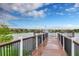 Wooden dock extending over lake with fountain view at 8886 Geneve Ct, Kissimmee, FL 34747
