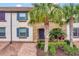 Townhouse exterior with blue shutters and palm trees at 8886 Geneve Ct, Kissimmee, FL 34747