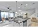 Open kitchen with island and view into living room at 8886 Geneve Ct, Kissimmee, FL 34747