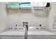 Bright laundry room with Whirlpool washer and dryer, plus shelving at 8886 Geneve Ct, Kissimmee, FL 34747