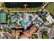 Aerial view of community pool, sports courts, and residential homes at 8886 Geneve Ct, Kissimmee, FL 34747