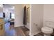 Bathroom area featuring a toilet, a bathtub with shower, and an entrance to the bedroom at 8919 Shine Dr, Kissimmee, FL 34747