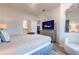 Well-lit bedroom featuring a comfortable bed, TV, and a decorative mirror, perfect for relaxing at 8919 Shine Dr, Kissimmee, FL 34747