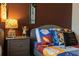 Themed bedroom with a comfortable bed, decorative pillows, and playful accents at 8919 Shine Dr, Kissimmee, FL 34747