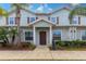 Charming two-story home with tropical landscaping, inviting entrance, and attractive architectural details at 8919 Shine Dr, Kissimmee, FL 34747