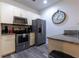 Well-lit kitchen features stainless steel appliances, granite countertops, and modern cabinetry at 8919 Shine Dr, Kissimmee, FL 34747