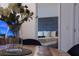 Cozy dining table arrangement with a view into a well-lit modern bedroom and a comfy living room at 8919 Shine Dr, Kissimmee, FL 34747