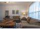 Bright living room showcases neutral tones, contemporary decor, and a large window for ample lighting at 8919 Shine Dr, Kissimmee, FL 34747