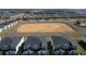 Aerial view of a community with a large empty field at 9234 Sommerset Hills Dr, Davenport, FL 33896