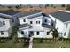 Modern home with a metal roof and light-stone exterior, in a residential area at 9234 Sommerset Hills Dr, Davenport, FL 33896