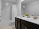 Double vanity bathroom with dark cabinets and tiled floor at 9234 Sommerset Hills Dr, Davenport, FL 33896