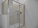 Clean bathroom with walk-in shower and marble tile at 9234 Sommerset Hills Dr, Davenport, FL 33896