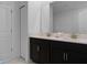 Double vanity bathroom with dark wood cabinets and marble flooring at 9234 Sommerset Hills Dr, Davenport, FL 33896