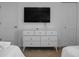 Bedroom with dresser and mounted TV at 9234 Sommerset Hills Dr, Davenport, FL 33896