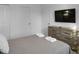 Modern bedroom with large TV and dresser at 9234 Sommerset Hills Dr, Davenport, FL 33896
