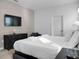 Bright bedroom with king-size bed and built-in media wall at 9234 Sommerset Hills Dr, Davenport, FL 33896