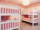 Pink bedroom with bunk beds and princess theme at 9234 Sommerset Hills Dr, Davenport, FL 33896