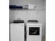 Laundry room with washer, dryer, and shelving for storage at 9234 Sommerset Hills Dr, Davenport, FL 33896