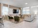 Open living room with large TV, comfortable seating, and natural light at 9234 Sommerset Hills Dr, Davenport, FL 33896