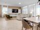 Open living room featuring comfortable seating and large TV at 9234 Sommerset Hills Dr, Davenport, FL 33896