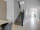 Modern staircase with gray carpet and black railings at 9234 Sommerset Hills Dr, Davenport, FL 33896