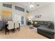 Open living room with gray sectional sofa, dining area, and vaulted ceilings at 2507 Talega Dr, St Cloud, FL 34772