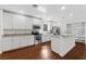 Modern kitchen with white cabinets, granite counters, and stainless steel appliances at 1009 Wiregrass St, Celebration, FL 34747