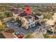 Beautiful aerial view of the tan townhome with two stories, garage, and two balconies in a neighborhood with ample parking at 12209 Wild Iris Way # 110, Orlando, FL 32837