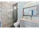 Modern bathroom with marble shower and gray vanity at 12209 Wild Iris Way # 110, Orlando, FL 32837