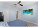 Bedroom with mounted TV and ceiling fan at 12209 Wild Iris Way # 110, Orlando, FL 32837