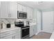 Modern kitchen with stainless steel appliances and white quartz countertops at 12209 Wild Iris Way # 110, Orlando, FL 32837