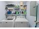Laundry room with washer, dryer, and shelving at 12209 Wild Iris Way # 110, Orlando, FL 32837