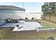 Cozy backyard patio features a paved seating area and raised garden beds at 1239 Berry Ln, Davenport, FL 33837