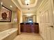 Bathroom with double sinks, bathtub, shower, and elegant decor at 1350 Centre Court Ridge Dr # 401, Reunion, FL 34747