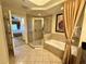 Tiled bathroom featuring a shower and a bathtub with gold accents at 1350 Centre Court Ridge Dr # 401, Reunion, FL 34747