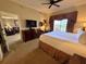 Spacious bedroom features a king bed, dresser, desk, and a view into a cozy living room at 1350 Centre Court Ridge Dr # 401, Reunion, FL 34747